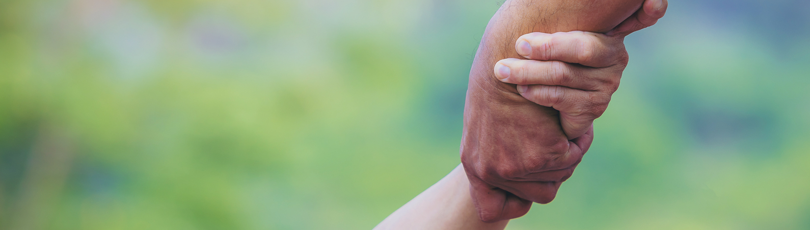 Older holding the hand of younger person